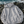 Hoodie à capuche HONO coton bio gris chiné, sweat surf éco-responsable avec logo poitrine sur des rochers en bord d'océan.