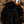 Hoodie à capuche HONO coton bio noir, sweat surf éco-responsable avec logo poitrine, mise en scène plage, sable et accessoires surf lifestyle.