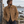 Surchemise HONO en velours côtelé  bio camel  brodée bordeuax portée par un homme face à la mer, dans une ambiance naturelle et authentique du Finistère.