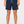 Boardshort surf homme HONO bleu marine en matière recyclée porté avec logo brodé jaune