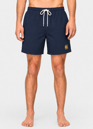 Boardshort surf homme HONO bleu marine en matière recyclée porté avec logo brodé jaune