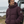 Doudoune chaude en nylon recyclé HONO Surfwear bordeaux portée par un homme face à l’océan
