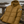 Doudoune chaude en nylon recyclé HONO Surfwear bronze posée sur une rambarde en bois face à l’océan
