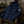Doudoune hiver navy écoresponsable HONO mise en scène dans une cabane de pêcheur, esprit surf et bord de mer