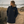 Imperméable recyclé bleu marine HONO porté par une femme, doublé en polaire recyclée, broderie jaune, vêtements de surf surfwear durable et éco-responsable, marque française