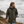 Imperméable kaki HONO doublé polaire avec capuche et broderie noire, porté par un homme face à la mer, surfwear bio écoresponsable et marque furf rançaise