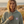 Femme portant un sweat à capuche oversize vintage Ocean Grey HONO sur la plage – hoodie surfwear durable en coton biologique-vêtement de surf