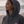 Femme portant un sweat à capuche vintage gris HONO Surfwear durable avec logo brodé sur la poitrine face à l’océan
